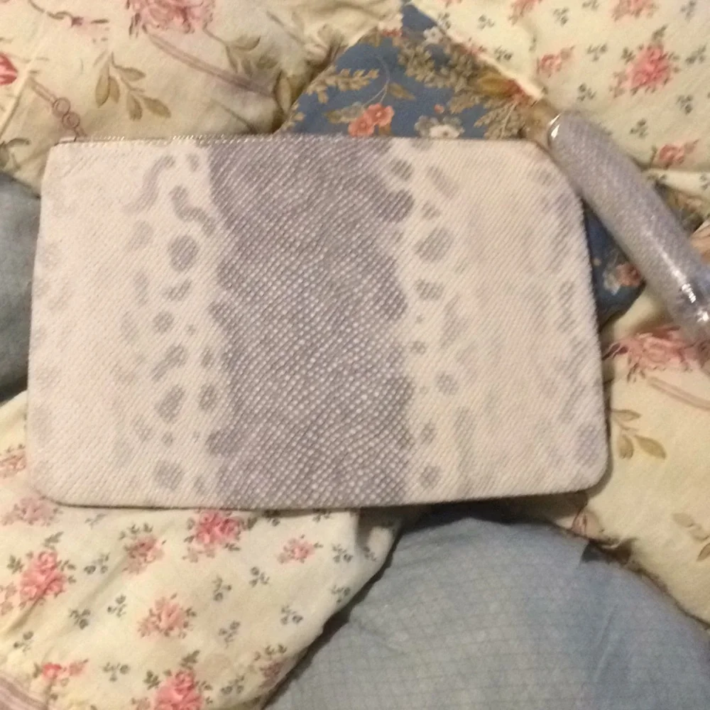 Gili pebble leather snow leopard wristlet